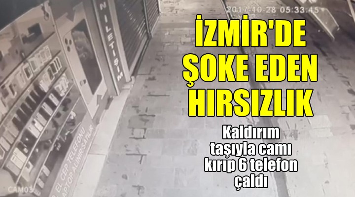 İzmir'de şoke eden hırsızlık! Kaldırım taşı ile camı kırıp 6 cep telefonu çaldı!